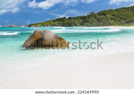 Granite boulders, perfect white beach and turquoise water at Anse Cocos in La Digue, Seychelles