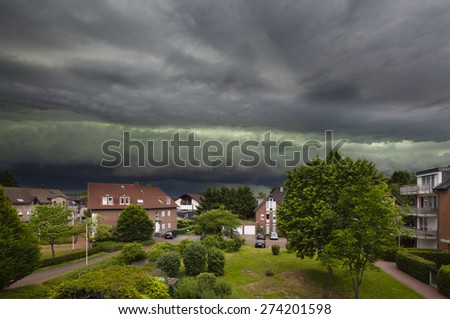 Spectacular cloud front of an upcoming thunderstorm turning day into night. The thunderstorm was one of the worst of the last decade in the west of Germany and caused heavy damage.