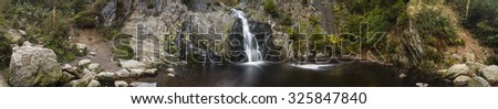 Panoramic view of a waterfall in a canyon in the High Fens, Ardennes, Belgium. Long exposure shot.