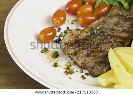 Beef steak medium grilled, on dish
