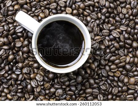 Cup of coffee, on the coffee beans background