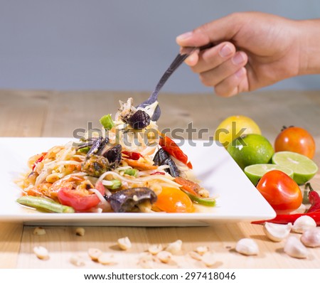 Eating Som Tam (Spicy Papaya Salad) with salted crab, Thai food , blur, select focus style