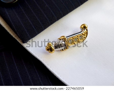 Cuff link for a cuff on a shirt in the form of an ancient knife