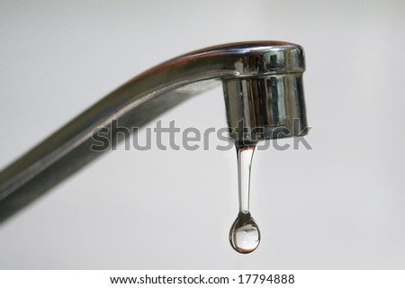 water drop falling from a kitchen tap