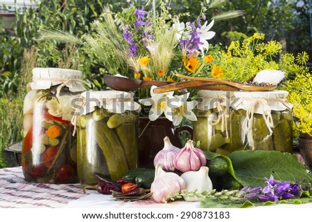 Banks with pickled vegetables - cucumbers, tomatoes, zucchini, and all the ingredients for their salting and preservation-salt, sugar, allspice, pepper, chili hot pepper, bay leaf, spices, dill,garlic