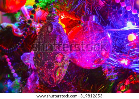 Christmas decorations on the Christmas tree, Christmas and New Year, lights and color. Feast of the tale. Celebration. Beads, Christmas balls and Christmas ornaments.