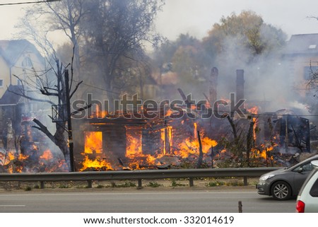 Russia, Moscow, Mytishchi, October 1, 2014 - the Yaroslavl highway, M8, work to expand the road, the house is burning, the fire are fire engines, firefighters are working on the road going cars.