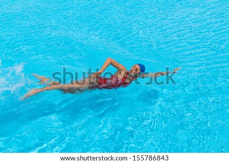 Woman swims freestyle in the pool