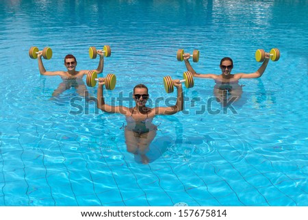 Happy Active Fitness People Doing Exercise With Aqua Dumbbell
