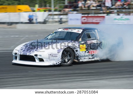Lvov, Ukraine - June 7, 2015: Unknown riders on the car brand Nissan and BMW overcomes the track in the championship of Ukraine drifting in Lvov, Ukraine
