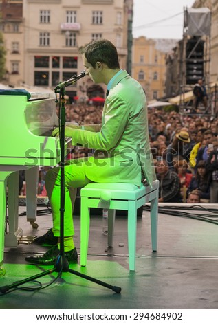 Lvov, Ukraine - 25 June 2015: Alfa Jazz Fest 2015. Antony Strong playing piano on stage jazz festival on the Market Square in Lvov near the town hall.