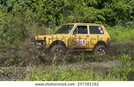 Lvov, Ukraine - May 30, 2015: Off-road vehicle VAZ-NIVA (No. 710) overcomes the track on of landfill near the city Lvov.