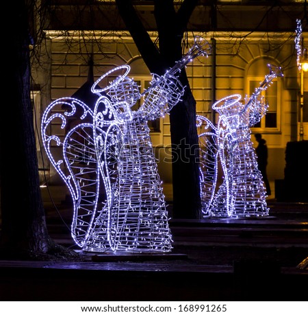 Christmas street decorations - angels playing trumpets made of light bulbs fitted to a metal skeleton