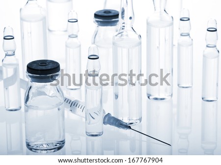 Glass Medicine Vials with liquid, botox, hualuronic, collagen, flu ampoules and syringe.