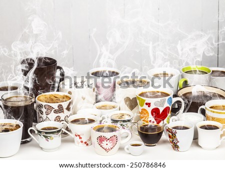 Lots of coffee in different cups with hearts and flowers. Copy space.