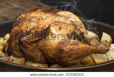 Delicious baked chicken with potatoes in a pan.