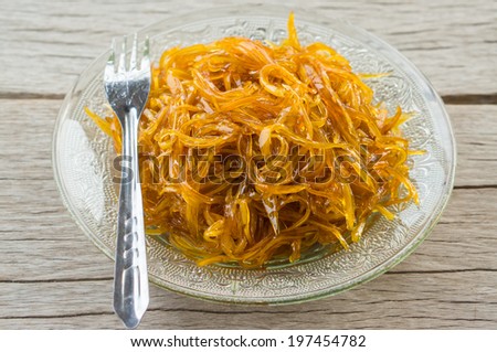mango stirred connect by sugar on dish with wood texture background, thai food