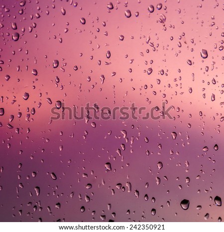 close up Raindrops on the window, background out of focus, Shades of Red color