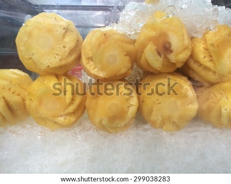 close up of pineapple on ice box for sale