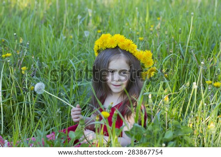 little girl with a dandelion in hands