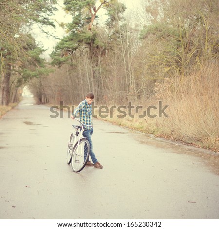 man resting near a bicycle in the park