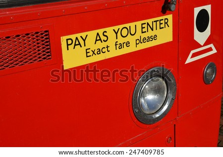 Pay as you enter sign on vintage British public transport bus.