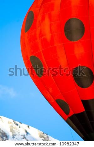 black points on a red hot air balloon