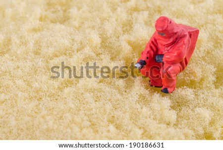 miniature scientist checking bacterial on the cleaning pad