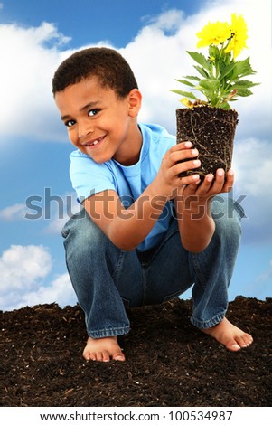 Adorable  Black Boy Child Planting Flowers for Earth Day Barefoot in Soil Holding Flower