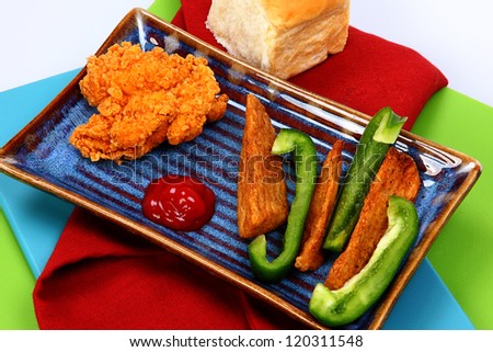 Small Portion Fried Chicken Tender with Potato Wedges and Green Bell Pepper