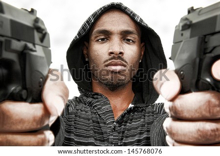Angry Young Black Adult Male with Handguns