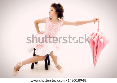 Beautiful Caucasian Girl Child in Pink Lolita Style Fashion with Polka Dot Umbrella