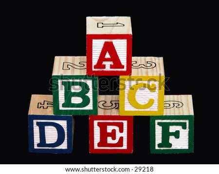 Kids alphabet blocks (a-f) on black.