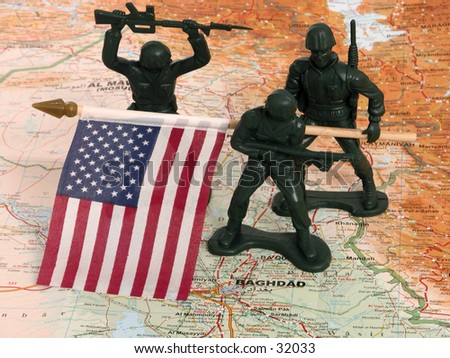 Plastic green army men with a US flag on a map of Iraq.