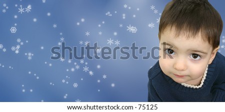 Adorable boy on a snowflake background looking up with his big dark eyes.