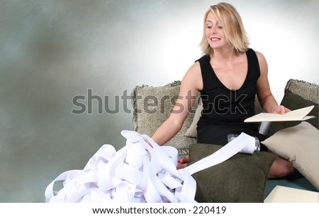 Beautiful Woman Doing Taxes or Budgeting at Home.