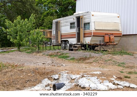 Small old camper used as home for low income family in America.