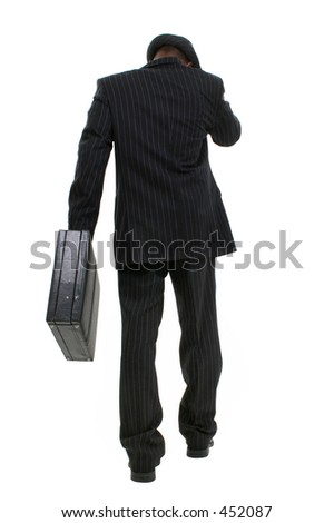 Attractive Business Man In Pin Striped Suit & Hat. Full body shot walking with briefcase away from camera.