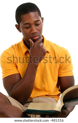 Attractive young man reading book.  Wearing yellow short sleeve shirt and khaki shorts. Shot in studio over white.