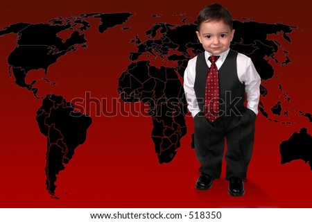 Adorable Toddler Boy In Suit Standing On The World.  Hands in pocket and a sweet smile.