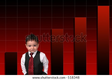 Adorable Toddler Boy In Suit Standing Against Bar Graph.  Hands in pocket and a sweet smile.