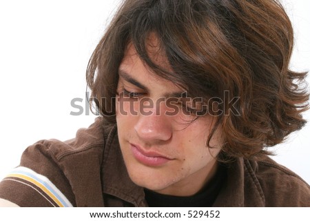 stock photo Close up of teen boy crying Tears in eyes and on cheeks