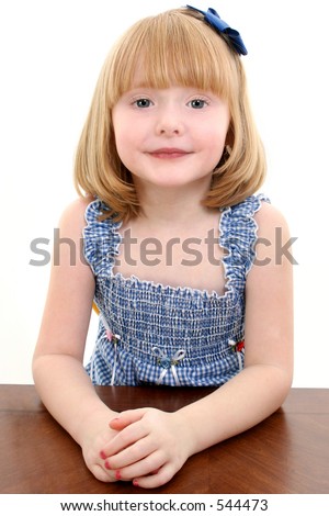  of beautiful 4 year old girl with strawberry blonde hair sitting at