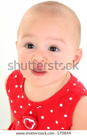 Close-up of a beeautiful Baby Girl with stork bite (telangiectatic naevus) on Upper Lip. Shot in studio over white.
