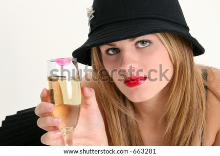 Beautiful Young Woman with Champagne Glass. Red lipstick stain on glass. Shot in studio.