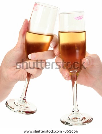 Two girls making a toast with champagne at a party. Lipstick marks on glasses.