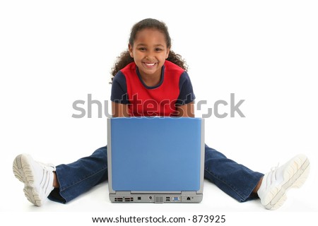 Beautiful African American preteen girl sitting on floor with laptop smiling.