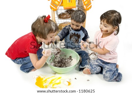 Three adorable toddlers (2, 3 and 4) stirring cake mix. Covered in chocolate batter, flour and eggs. Shot in studio over white.