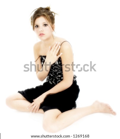 stock photo Beautiful teen girl sitting barefoot on white with black 
