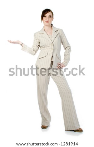 Beautiful young business woman in beige stripped suit over white.  Standing with hand held out to side.